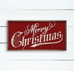 a wooden sign that says merry christmas on the side of a white wood plank wall