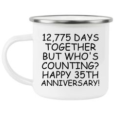 a white enamel mug with the words 20th anniversary printed on it and an inscription that reads,