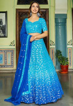 Readymade Faux Georgette Lehenga in Shaded Blue. This attire with Shantoon and Cotton Lining is Enhanced with Fancy Tassels, Resham and Sequins WorkAvailable with a Faux Georgette Blue Choli Crafted in Sweetheart Neck and Half Sleeves and a Faux Georgette Dupatta in Royal Blue. The Choli and Lehenga Lengths are 14 and 42 inches respectively. Do Note: Accessories shown in the image are for presentation purposes only. (Slight variation in actual color vs. image is possible). We sell all kinds of L Blue Sequined Sets For Reception, Blue Sharara With Sequins For Reception, Blue Sequined Sharara For Reception, Blue Sequined Choli For Reception, Blue Saree Sets With Sequins, Blue Sequined Sets For Wedding, Blue Sequined Wedding Set, Blue Sequined Sharara For Diwali, Blue Sequined Sets For Navratri