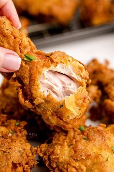 a person is picking up some fried food