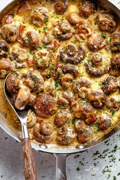 a skillet filled with meatballs and cheese