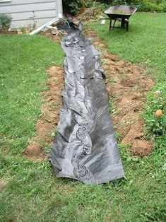 a black tarp covering the ground in front of a house with a fire hydrant