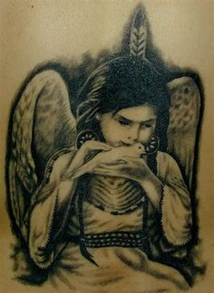 an angel tattoo on the back of a man's shoulder, with his hands clasped to his chest