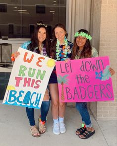 three girls holding up signs that say we run this beach