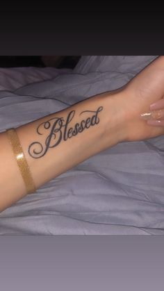 a woman's arm with a tattoo that says, blessed on it and the words below