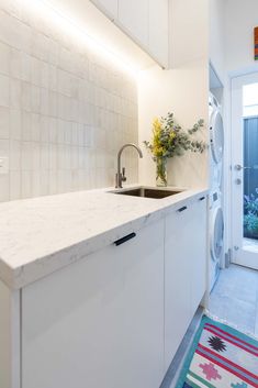 a kitchen with a sink, dishwasher and washing machine