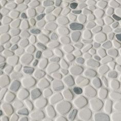 a close up view of the surface of a tile with rocks and pebbles on it