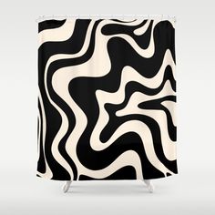 a black and white shower curtain with an abstract design on the front, featuring wavy lines