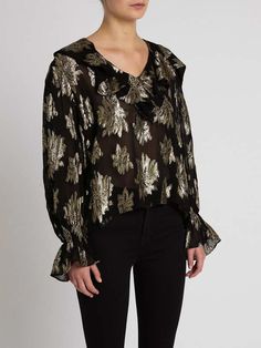 Make a statement in the labra top in black/gold by iro this season. constructed from a stunning viscose and lurex blend this long sleeved semi sheer blouse features billowy flared sleeves a floral print with a ruffle v neckline and is finished with a relaxed silhouette. pair with noir denim and leather boots for a feminine yet edgy vibe.    ---- fabric or composition    the iro labra top in black/gold is made from 70% viscose 30% lurex with 100% viscose lining    size and fit    the iro labra to Womens Printed Tops, Distressed Tee, Denim Flares, Sheer Blouse, Flared Sleeves, Print Tops, Leather Boots, Floral Print, Top Blouse