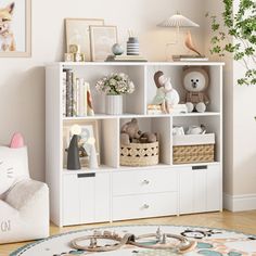 a white bookcase filled with lots of toys