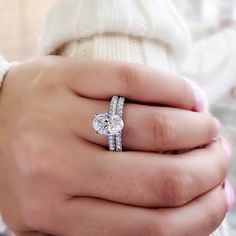 a woman's hand with a diamond ring on it