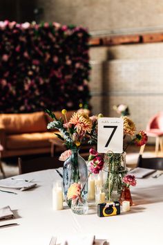 the table is set with flowers and candles