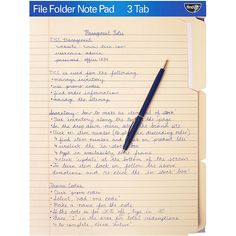 a notebook with a pen on top of it and the title file folder note pad 3 tab