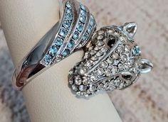 HOT TO TROT by Park Lane.  The horse wraps around your finger, with powder blue, crystal-encrusted face on one end and it`s tail on the other. *Hypoallergenic *Lead & Nickel free NWOT. Never worn. No scuffs, no missing stones. Excellent condition and quality.  Retails new over $65! #WearItAgainLove #preowned #preloved #jewelry #fashion #statement #accessories #beyourself #recycled **NOTE: When placing orders, please put all items needed together in one order. Due to shipping labels and tracking, Park Lane Rings, Park Lane Jewelry Rings, Horse Ring, Statement Accessories, Shipping Label, Park Lane, Shipping Labels, The Horse, Ladies Fashion