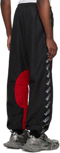 LU'U DAN.Black & Red Shell Track Pants.Nylon taffeta track pants..· Elasticized waistband and cuffs.· Two-pocket styling.· Logo patch at front.· Graphic-embroidered canvas trim at outseams.· Partial mesh lining.Supplier color: Black/Red.Body: 100% polyamide. Lining: 100% polyester..Made in Portugal..241331M191005 Embroidered Canvas, Clothing Pants, Pants Trousers, Personal Shopping, Track Pants, Patch Logo, Men's Clothing, Black Red, Portugal