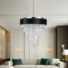 a living room filled with furniture and a chandelier hanging over the top of it