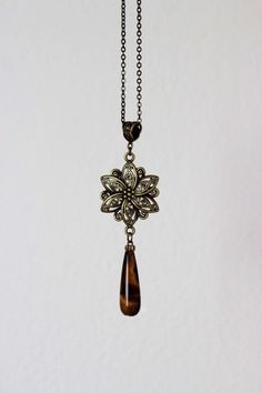 This long eautiful brass boho necklace was made of brown cat's eye stone drop bead, antique brass flower charm, brass bail, antique brass chain with antique brass tone lobster clasp. The chain is from lead free & nickel free metall. A wonderful jewelry for everyday wear and a great gift! Length of chain is about 68 cm or about 26,8 inches Other necklaces of my shop you can see here: https://www.etsy.com/shop/NaTavelli?section_id=14843046&ref=shopsection_leftnav_5 Thanks for a visit. Purple Stone Necklace, Long Stone Necklace, Anchor Jewelry, Brown Gemstone, Stainless Steel Chain Necklace, Necklace Purple, Single Bead, Brass Necklace, Amethyst Beads