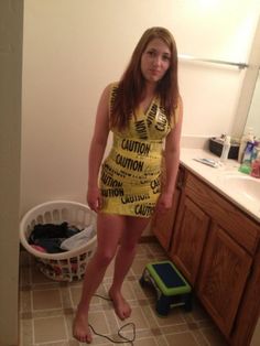 a woman in a yellow dress standing next to a bathroom sink with the caption caution her dad's a cop