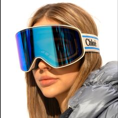 a woman wearing ski goggles and a jacket