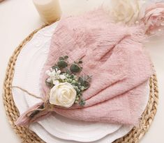 a pink hat with flowers on it sitting on top of a plate