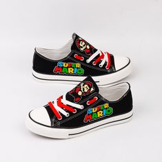 black and white sneakers with mario on the side, one shoe has red laces