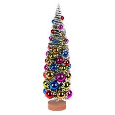 a multicolored christmas tree is shown on a wooden base with an ornament