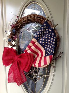 a wreath with an american flag hanging on the front door