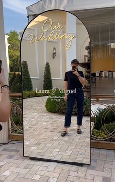 a woman taking a selfie in front of a mirror with the reflection of her