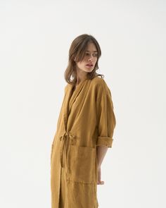 "Linen kimono robe with two little belts. Offered in heavy-weight linen. STYLE DETAILS * Loose fit * Straight cut * Two little belts / ties in the front * Two front pockets * Made from heavy-weight linen. SIZES & COLORS IN THE PICTURES * Model 1 is wearing size S/M in Honey Yellow (heavy linen). Model's height - 174 cm (5' 8\"), bust - 80 cm (31.5\"), waist - 60 cm (23.6\"), hips - 90 cm (35.4\"). * Model 2 is wearing size S/M in Wine Red (out of stock). Model's height - 176 cm (5'9\"), bust - 8 Urban Minimalist Fashion, Linen Jackets Women, Linen Duster, Linen Kimono, Linen Robe, Plus Size Kimono, Linen Coat, Honey Yellow, Kimono Coat