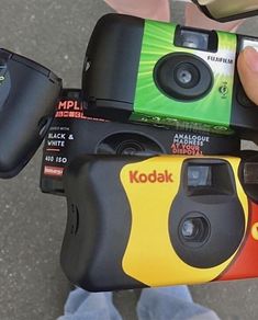 a person holding two cameras in their hands