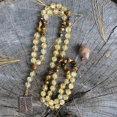 "So maybe prayer beads aren't your thing. I get it. Not everyone is into spirituality, gratitude practices, or mindfulness. Totally fine. I've got something for you too. 🤗 This beautiful, beaded necklace features the following: 8mm natural, polished, round Citrine 8mm star cut Yellow Tiger's Eye 10mm Brown Sandalwood connector bead Each bead is individually hand-knotted on durable, gold nylon thread and completed with a Tree of Life pewter pendant with an antique copper finish. 💛🤎 Each bead has been individually hand-knotted by me.✨ 💛 Citrine is called the \"stone of manifestation\". It is said to attract prosperity, wealth, and success. It imparts joy and cheerfulness on the wearer.  🤎 Yellow Tiger's Eye is known as the \"stone of courage\". It is said to attract good luck while incr Citrine Beads, Pewter Pendant, Tiger Eye Beads, Copper Finish, Tigers Eye, Tiger's Eye, Prayer Beads, Antique Copper, Tiger Eye