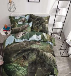 an image of a dinosaur bedding set with dinosaurs on the sheets and pillow cases