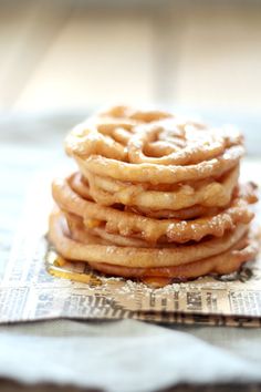 a stack of waffles sitting on top of a piece of paper with powdered sugar