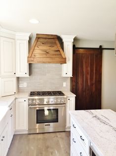 a stove top oven sitting inside of a kitchen next to an oven and countertop