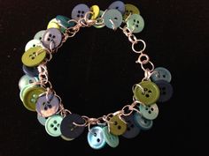 a close up of a bracelet with buttons on it