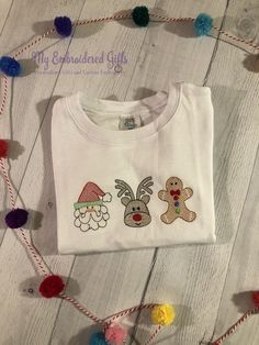 How cute are these three Christmas friends? Santa, Rudolph, and the Gingerbread Man make a cute Christmas shirt. Embroidery makes this a wonderful keepsake shirt. We use boutique quality shirts from ARB Blanks or Blossom Blanks depending on availability. All of our embroidered shirts feature Cloud Cover on the back side to protect your child's skin for a rough surface. Available Shirt Sizes: 12 months through 8 See pictures for sizing charts. Need something a little different? Message us to disc Girls Christmas Shirts, Boys Christmas Shirt, The Gingerbread Man, Christmas Friends, Embroidered Shirts, Cute Christmas Shirts, Embroidered Christmas, Embroidered Gifts, Crochet Stitches Video