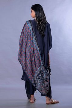 Midnight navy blue kurta with hand embroidered ajrakh patch work, coin tassels. Comes with slim fit ankle length pant and ajrakh dupatta.
Component: 3
Pattern: Embroidered
Type Of Work: Ajrakh Work
Neckline: Round
Sleeve Type: Batwing Sleeves
Fabric: Kurta and Pant: Satin Silk; Dupatta: Handloom Ajrakh Satin
Color: Blue
Other Details: 
Asymmetric hem
Embroidered cuff hem sleeves
Coin tassel details
Hand embroidered with gold sequin, Zari thread and Pitta detailing
Occasion: Puja - Aza Fashions Blue Mulmul Palazzo Set With Printed Motifs, Bohemian Blue Block Print Anarkali Set, Blue Bohemian Chanderi Palazzo Set, Bohemian Mulmul Sharara With Block Print, Blue Bohemian Designer Wear Dupatta, Blue Bohemian Style Designer Wear Dupatta, Blue Kalamkari Print Anarkali Set For Eid, Blue Bohemian Salwar Kameez In Mulmul, Blue Kalamkari Anarkali Set For Eid