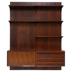 a wooden bookcase with drawers and shelves on the front, against a white background