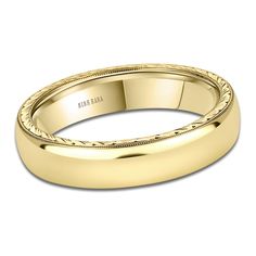 a yellow gold wedding band with engraving on it