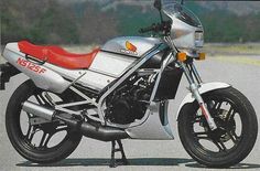 a silver and red motorcycle parked on the street