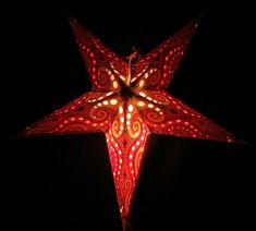 a red and white star shaped light in the dark