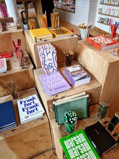 many books and pens are on display in the store's wooden cased shelves