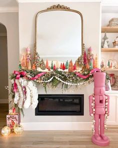 a fireplace decorated for christmas with pink decorations