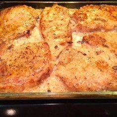 some meat patties are in a glass baking dish on the stove top, ready to be cooked