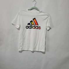 Nwt Adidas Kids White T-Shirt Size 10-12 Retail Price $20.00 Adidas Multicolor Graphic Print T-shirt, Sporty Multicolor Adidas Tops, Adidas Sporty Multicolor Tops, Adidas Multicolor Crew Neck T-shirt, Adidas Multicolor Short Sleeve Tops, Adidas Multicolor Graphic Print Tops, White Adidas Graphic Tee, Adidas Multicolor Casual Tops, White Adidas Graphic Tee With Logo