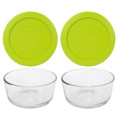 three glass bowls with lids are shown in front of each other on a white background