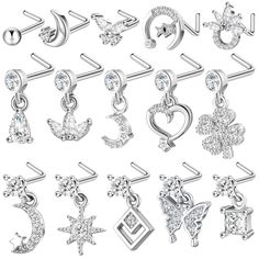 an assortment of silver colored earring designs with crystal stones on each side and the letter c