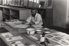 a man sitting at a table with lots of papers