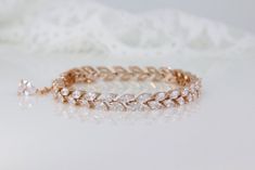 "The timeless 'Hayley' bracelet is handcrafted with superb quality zircon crystals and set in a staggered marquise design.  This delicate accessory coordinates perfectly with our earring range, for a stunning matching look.  Set in a 16K rose gold tarnish-resistant base. * Lengths- 6\" & 7\" * Fitted with a lobster clasp and optional small extender  * Shopping for your bridal party? Access special pricing by contacting us. * Tarnish free, nickel free * Shopping for your bridal party? Access spec Elegant Rose Gold Crystal Bracelet For Anniversary, Delicate Rose Gold Cubic Zirconia Bracelets, Rose Gold Diamond Bracelet With Accents For Wedding, Rose Gold Hand Set Tennis Bracelet For Wedding, Dazzling Rose Gold Wedding Bracelets, Rose Gold Jubilee Tennis Bracelet For Wedding, Fine Jewelry Rose Gold Tennis Bracelet For Wedding, Fine Jewelry Rose Gold Bracelets For Wedding, Dazzling Rose Gold Bracelets With Diamond Cut