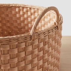 a woven basket sitting on top of a wooden table